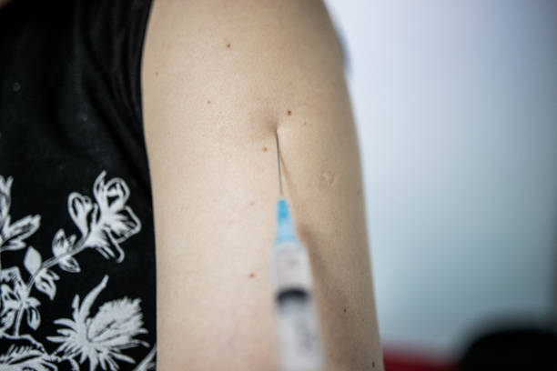 istock Syringe with vaccine, injection in the shoulder 1308249050
