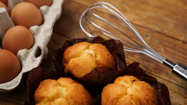 istock Baked cupcakes and muffins on a rustic wooden background 1308249346