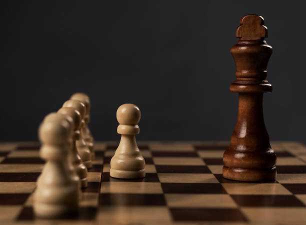 istock Group of pawns before king on chess board, concept 1308250868