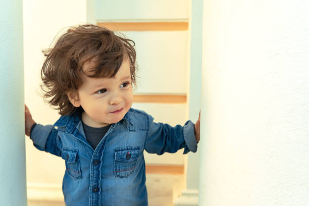 istock Modern long-haired boy with a smile, looking aside outdoors 1308251278