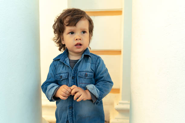 istock Modern long-haired pensive boy looking aside outdoors 1308251313