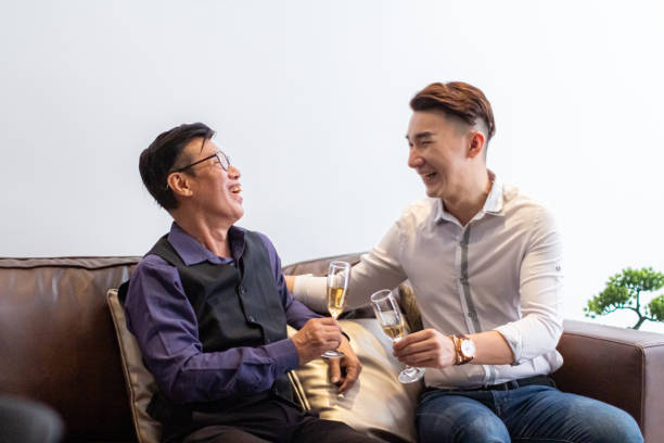 Asian Men Enjoy Champagne Together