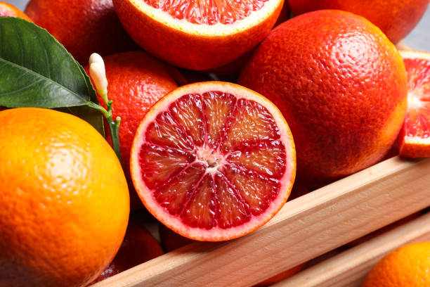istock Ripe red oranges in wooden crate, closeup 1308255471