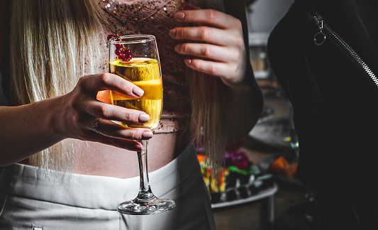 glass of champagne in woman hand at a party