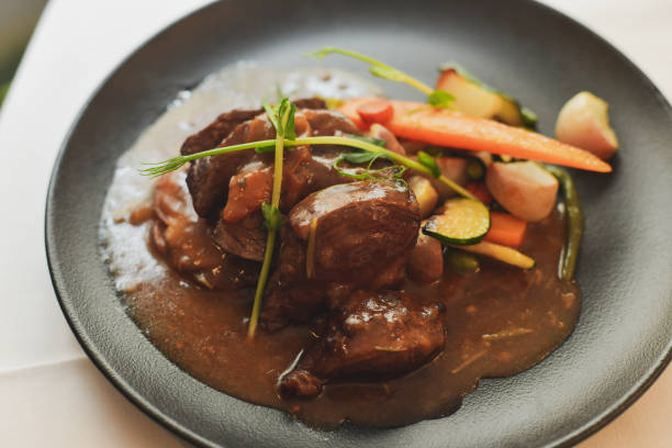 istock Beef Bourguignon with vegetables in a black plate 1308257765