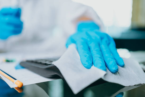 istock Scientists are cleaning calculate by alcohol and tissue after checking and testing virus on labtop at home. 1308262462