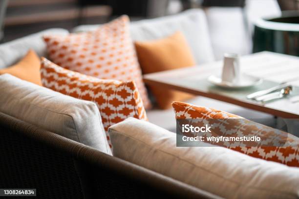 Close Up Colorful Soft Pillows Cushion Arrange On Nature Material Dining Chair With Blur Patio Area Background Interior Design Concept Stock Photo - Download Image Now