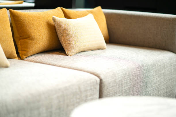 close up soft  pillow cushion attange on sofa at garden patio hotel area furniture design ideas concept stock photo
