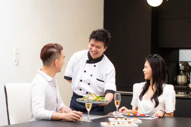 Photo of Private chef serve food to asian couple