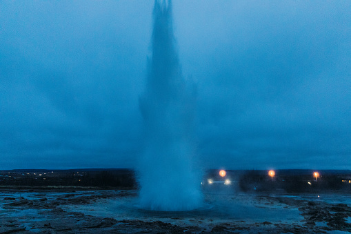Scenic view o the famous Geysir surrounded by the volcanic landscape during twilight in Iceland