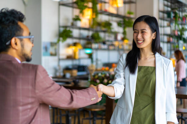 istock Asian Business team doing a business hand shake. 1308266490