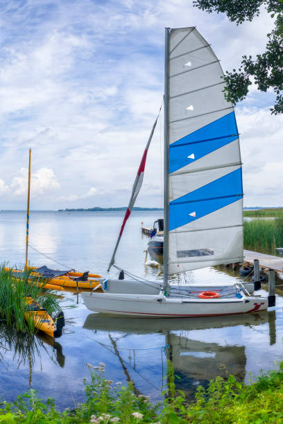 Vacations in Poland - sailing in Masuria, land of a thousand lakes Vacations in Poland - sailing on the Lake Sniardwy, the largest lake in Masuria, land of a thousand lakes sailboat mast stock pictures, royalty-free photos & images