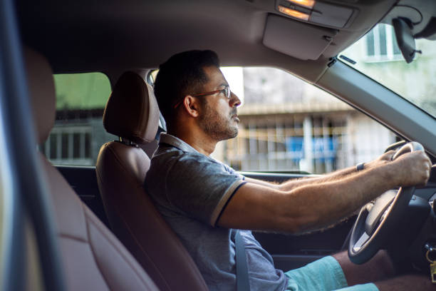 istock Businessman driving a car 1308267541
