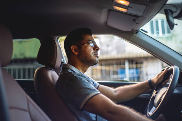 istock Businessman driving a car 1308267568