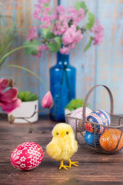 istock Easter. Basket with painted Sorbian Easter eggs, magnolia and chicks 1308269042