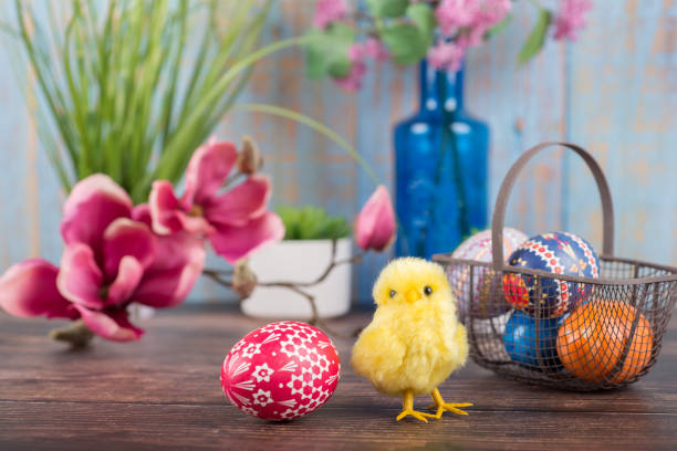 istock Easter. Basket with painted Sorbian Easter eggs, magnolia and chicks 1308269074