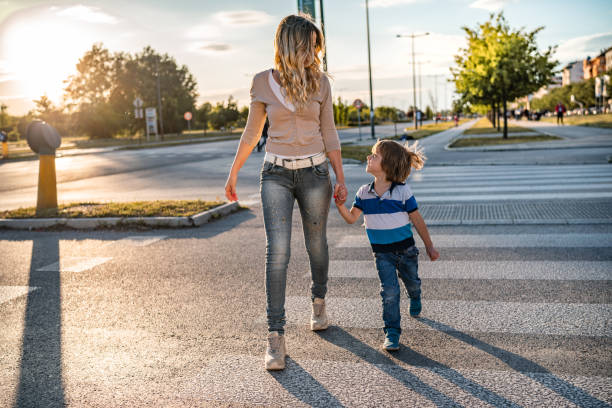istock Mom and son crossing the road 1308270410