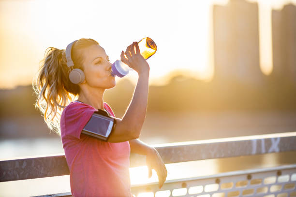 istock Sporty woman drinking water 1308271392