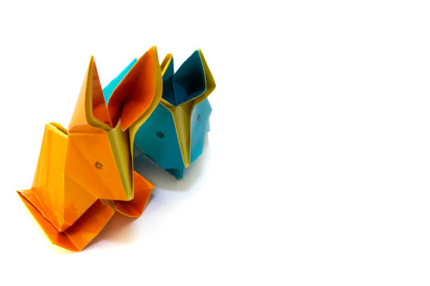 istock Origami rabbits from colored paper. Easter hares. Isolated on white background 1308271581