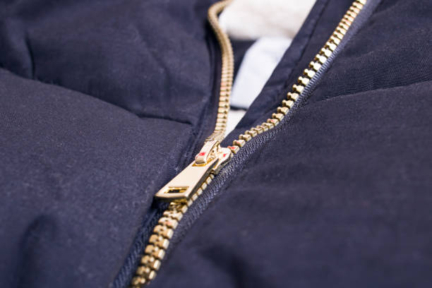 istock Metallic yellow zipper on a black jacket 1308271913