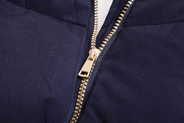 istock Metallic yellow zipper on a black jacket 1308271959
