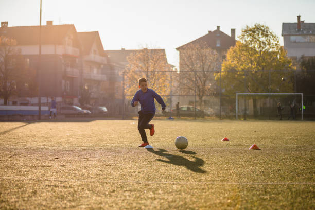 istock Young boy chasing the ball 1308272063