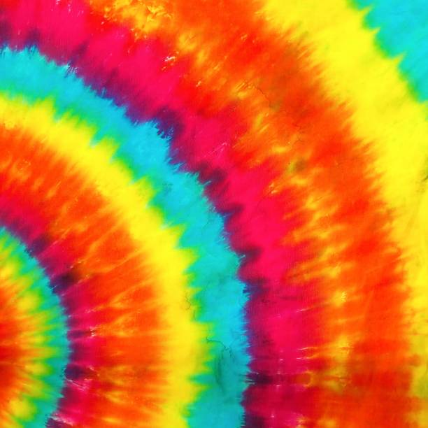 Tie dyed. A closed up pattern of tie-dyed texture in colorful rainbow theme (yellow, blue, pink and orange). stock photo