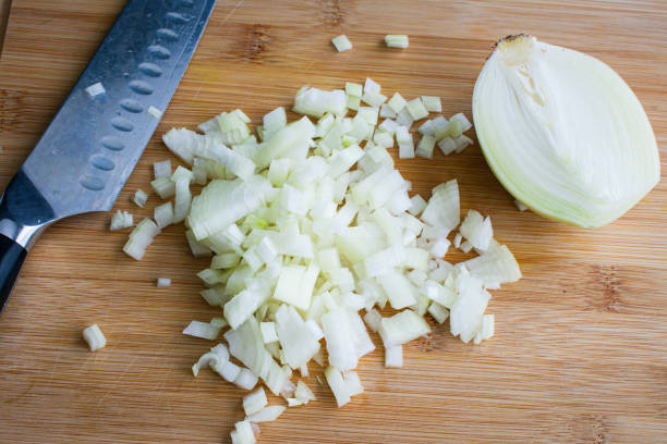 istock Finely Chopped Yellow Onion with Chef's Knife 1308274359