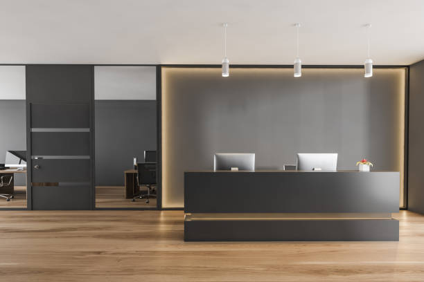 istock Black and wooden reception room desk with computers, conference office room 1308274732