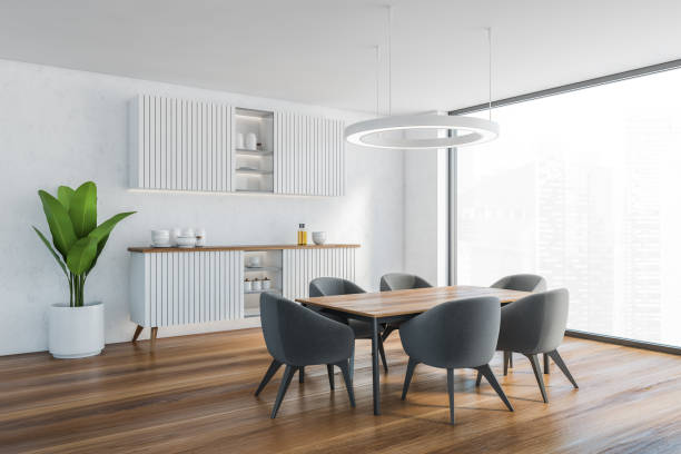istock White living room with commode and table with grey chairs near window 1308275543