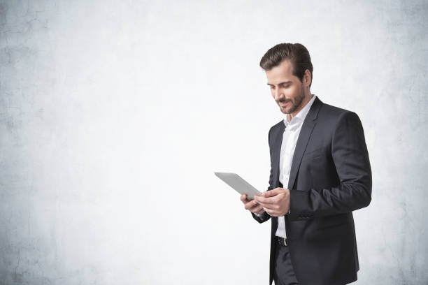 istock Bearded young businessman with tablet, mock up 1308275895