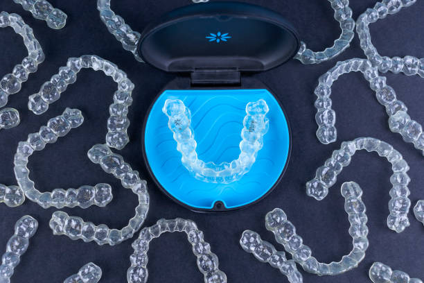 Plastic case with invisible transparent orthodontic retainers invisalign on black background. Aligner brackets or braces dental container Plastic case with invisible transparent orthodontic retainers invisalign. Aligner brackets or braces dental container dental aligner photos stock pictures, royalty-free photos & images