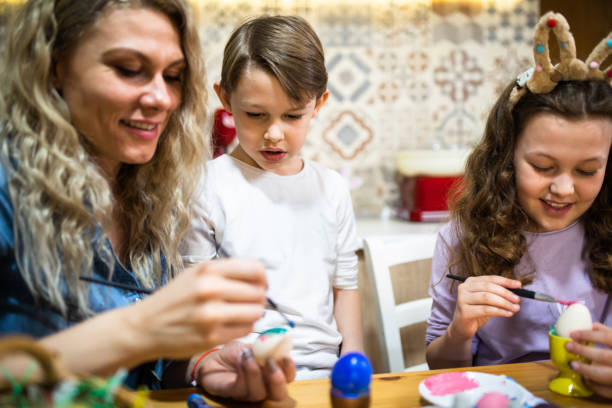 istock A lovely family decorating Easter eggs 1308279047