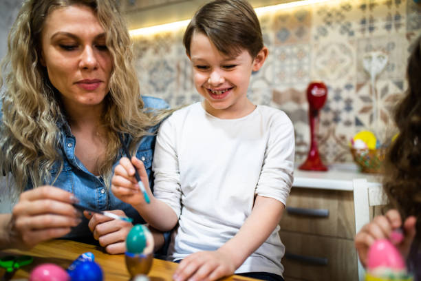 istock A happy boy coloring Easter eggs with his mom 1308279055