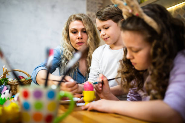 istock A family coloring eggs at Easter 1308279083