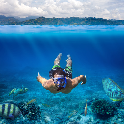 Underwater shoot of a young man snorkeling in a tropical sea. vacation concept
