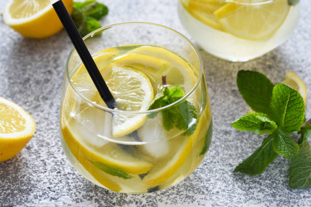 istock Fresh summer drink. Cold lemonade with mint on a concrete background. 1308282537