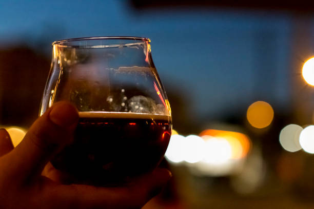 istock Glass of beer in hand 1308282565