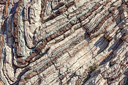 Texture, background layers  in sedimentary limestone rock on cliff face. South of Crete island. Greece. Europe.