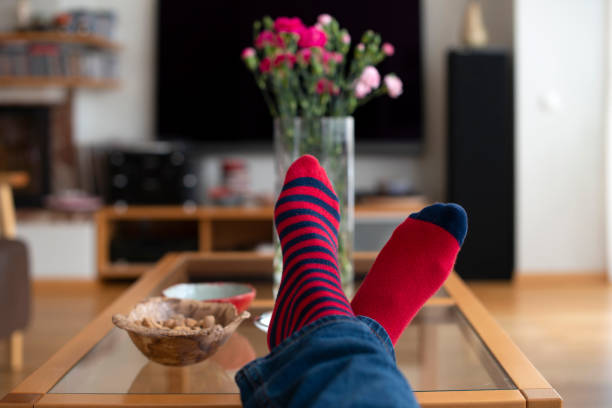 istock Feet in red socks resting on the table. 1308285426