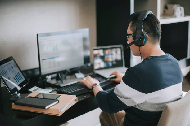 istock asian chinese mature man working from home routine with headset videocall with his colleague coworking 1308286571