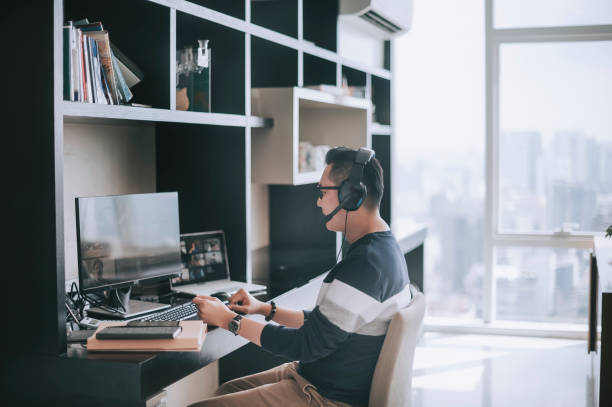 istock asian chinese mature man working from home routine with headset videocall with his colleague coworking 1308286580