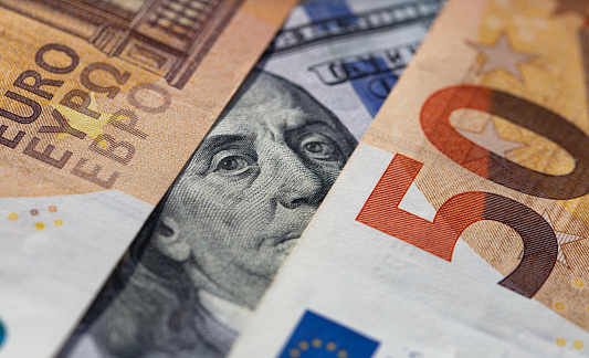 American dollars and European euros close-up, different convertible currencies of euros and dollars together