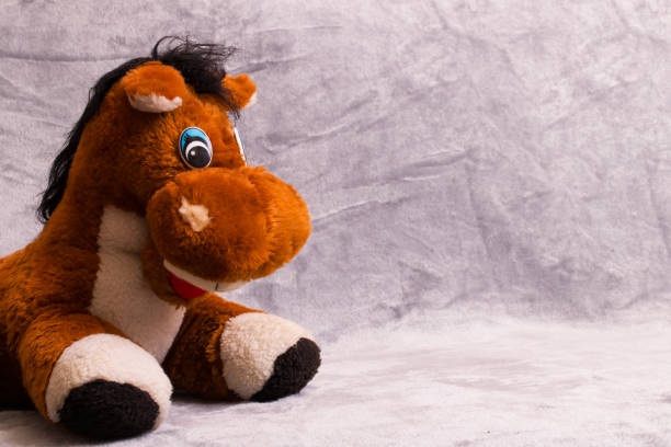 istock Soft plush toy horse on gray background 1308287627