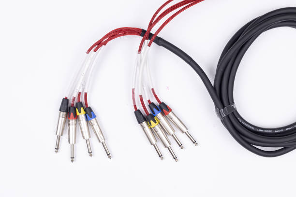 istock Audio guitar and microphone cable isolated above white background 1308289234