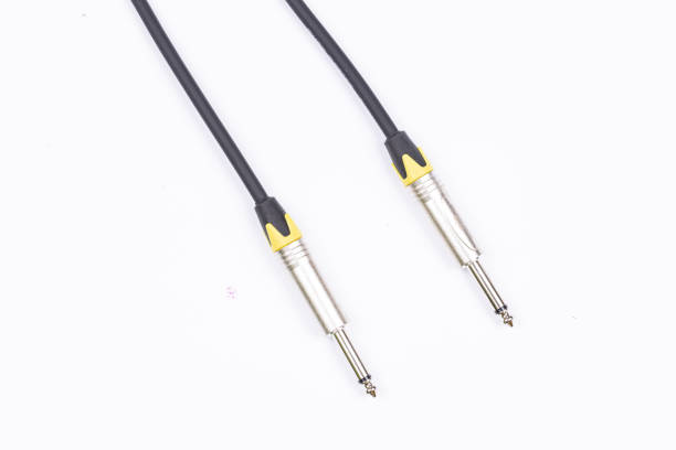 istock Audio guitar and microphone cable isolated above white background 1308289352