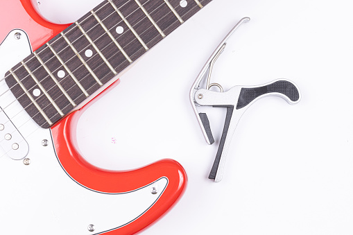 Electric Guitar with Capodastro isolated above white background