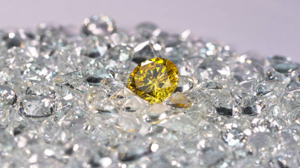 istock Yellow sapphire diamond on a pile of white diamonds. 1308290674