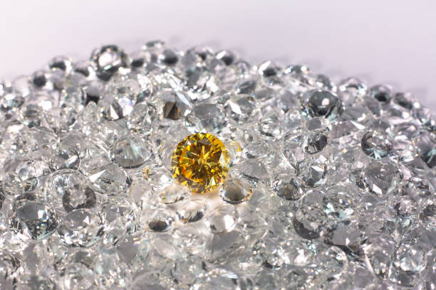 istock Yellow sapphire diamond on a pile of white diamonds. 1308290678