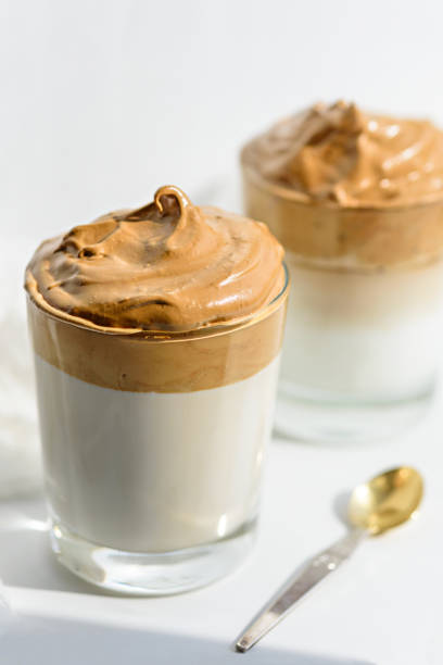 istock vertical trendy korean coffee in two glasses on white background, dalgona coffee concept 1308291775